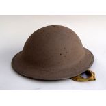 A WWII British Army `battle bowler` helmet painted in desert colours with internal webbing and