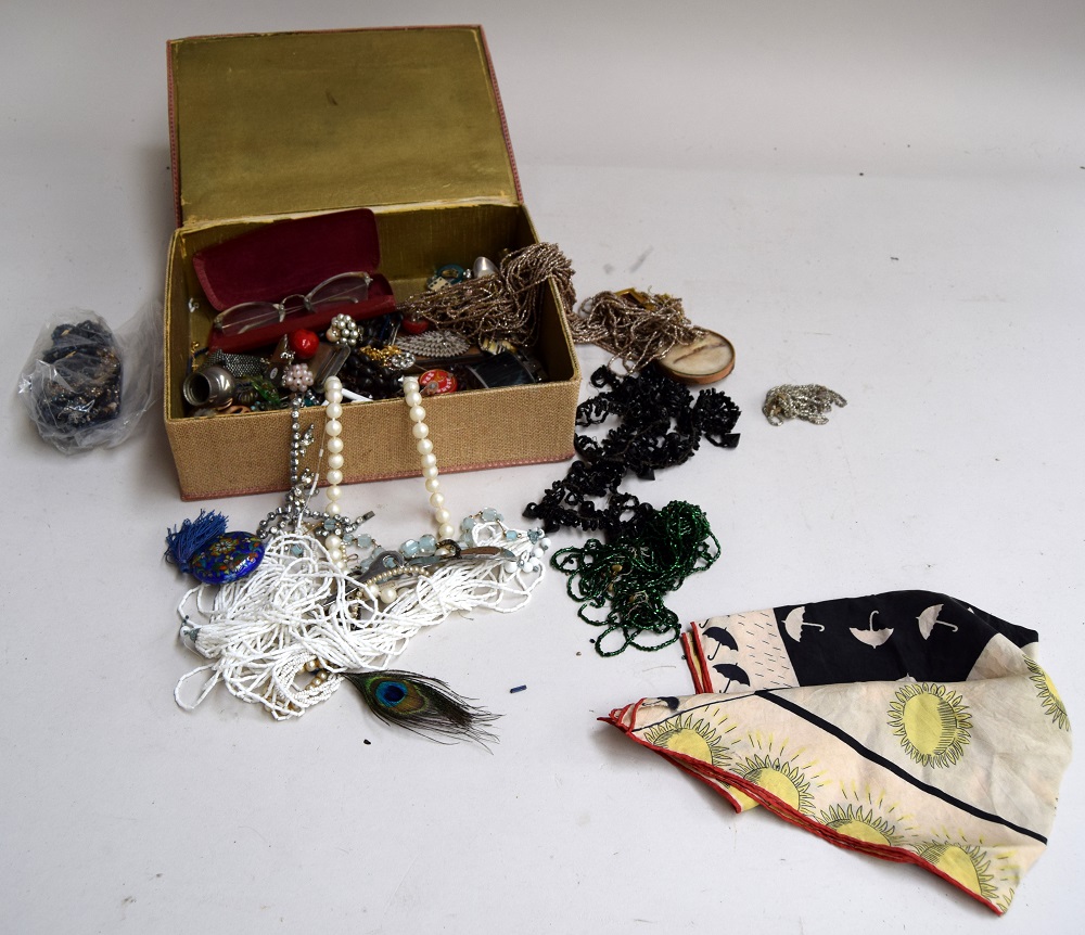 An embroidered box of costume jewellery;