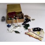 An embroidered box of costume jewellery;