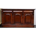 A mahogany 20th century sideboard with three cupboard doors divided by acanthus leaf scroll