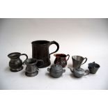 A small pewter half pint tankard stamped 'ER 576'; another stamped 1/10 pint; one other ;