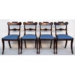 A set of four Regency mahogany dining chairs on sabre legs with blue drop in seats