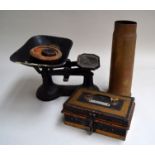 A set of vintage scales, cash box, and WW1 shell case 29.