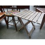 A small stool with mosaic top and a folding garden table