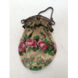 A finely beaded evening bag depicting pink roses buds and leaves with silver frame and chain and