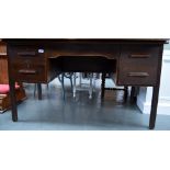 A kneehole desk, the apron flanked by two drawers,