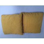 Two feather cushions covered with slubby yellow linen.