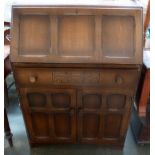 A bureau with fitted interior over long drawer and cupboard base,