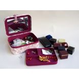 A fabric jewellery box containing some costume jewellery and other items and a platinin wedding