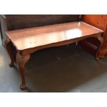 A low burr walnut table with floriate topped cabriole legs