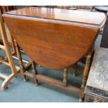 A drop leaf kitchen table on turned legs,