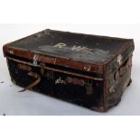 A vintage travel trunk with leather fittings inscribed R.