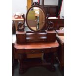 A Victorian mahogany dressing table, a central drawer flanked by three smaller drawers to each side,