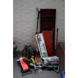 A collection of garden tools including a hedge trimmer, flymo, loppers,
