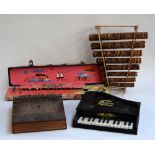 A collection of four unusual instruments - a thumb organ, Nardan harp, 'Baby Piano', xylophone,