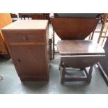 A bedside table with drawer above cupboard and a small drop leaf side table