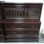 A Globe Wernicke bookcase with leaded glass over two long drawers, bears label,