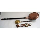 A large copper bed warming pan with a miniature in brass together with a banjo barometer and