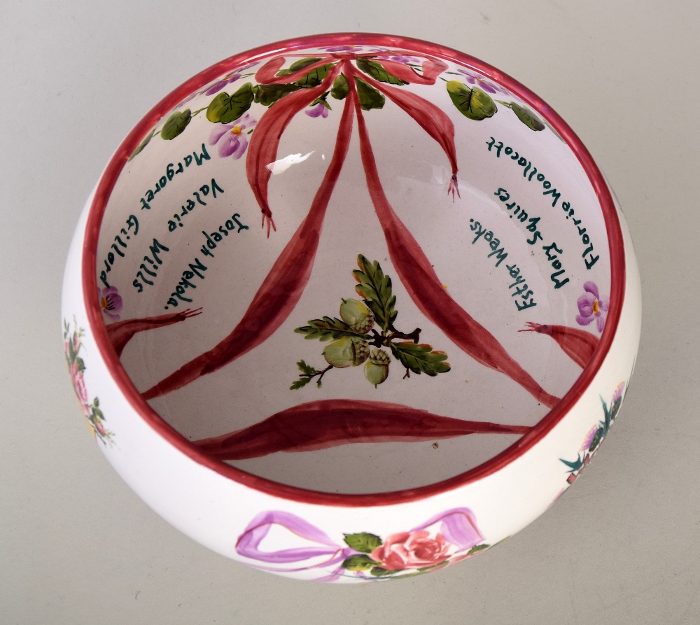 A Wemyss Ware one of a kind hand painted bowl, decorated with roses connected by swathes,