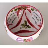 A Wemyss Ware one of a kind hand painted bowl, decorated with roses connected by swathes,