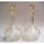 A pair of club decanters on rounded foot with slice cut detail to the neck and shoulders and