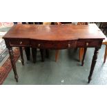 A mahogany side table with serpentine front, the central drawer flanked by two short,