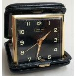 Looping 7 Jewel Lever travel clock in black leather case,