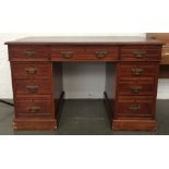 A mahogany kneehole desk with green leather skiver,