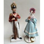 Two continental ceramic figurines, the soldier marked 'S' below crown to base,
