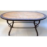 An Italian mosaic topped outdoor table with metal frame