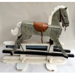 A vintage traditional style wooden painted rocking horse, dapple grey with leather tack,