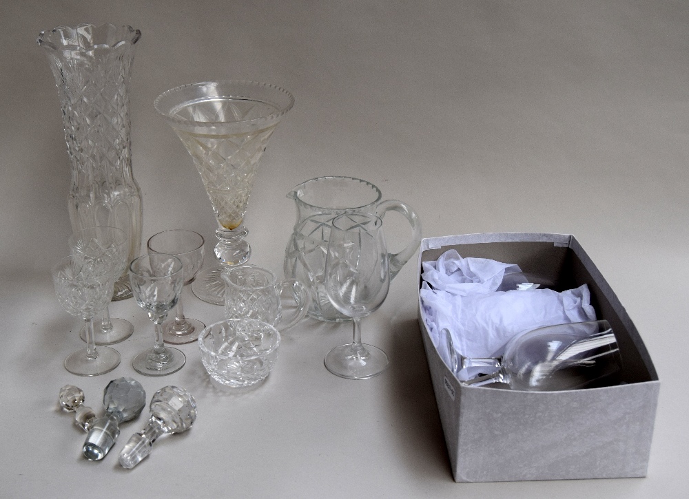 A selection of glass items including six champagne flutes, two cut glass vases, a cut glass jug,