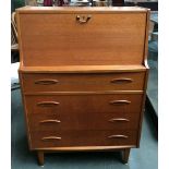 A mid-century bureau with fitted interior over four drawers