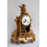 An antique French gilt bronze mantel clock, surmounted by a winged cherub, with two doves to base,