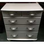 A white chest of two short over three long drawers