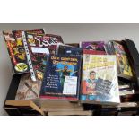 A box containing a collection of superhero comics and annuals, including Conan, Spiderman,