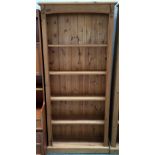 A pine bookshelf with plinth base,