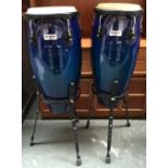 A pair of blue Headliner percussion congas,