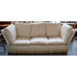 A knole three seater sofa upholstered in cream striped fabric