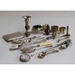 A mixed lot of silver items; three napkin rings, a candlestick, a sugar spoon with pierced handle,