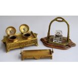 An ornate brass double inkstand, decorated with floral scrolls, and octagonal motif to sides,