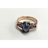 An Art Deco yellow metal ring with pale blue stone,