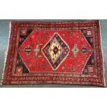 West Persian rug on red background,