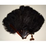 A collection of four Victorian and Edwardian fans, chocolate brown ostrich feather,