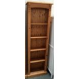 A pine bookshelf with plinth base,