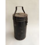 A large vintage vacuum flask, in black painted metal, marked 'Glass, handle with care' on lid,