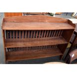 An arts and crafts style mahogany bookcase with three shelves and slatted back, 123x24.