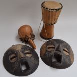 Two round African Ashanti masks, wooden with metal detailing, each approximately 25cmD,