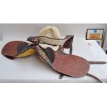 A western leather 18" riding saddle, 'The Australian Stock Saddle', tooled with a floral motif,