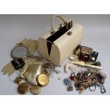 A vintage jewellery bag containing costume jewellery,